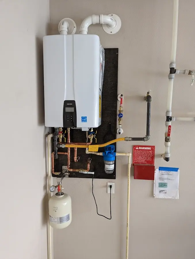 Professional plumber installing copper piping in a Eagan home